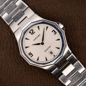 Concord Mariner 14.E7.1881 with silver sunburst dial and twelve-sided steel bezel on its integrated bracelet
