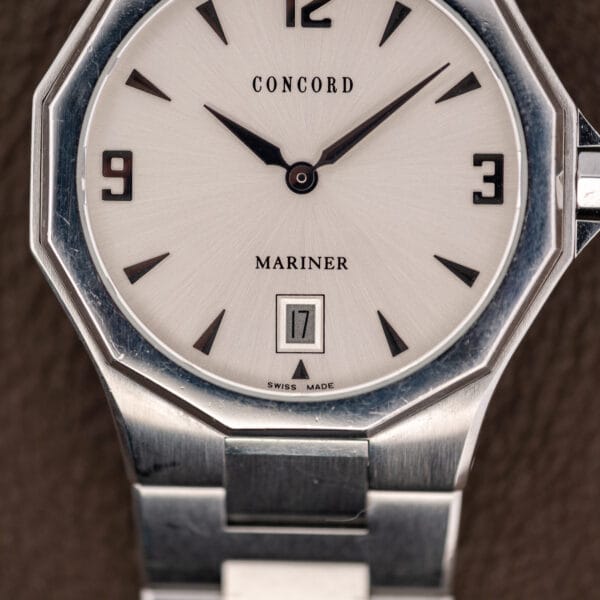 Dial detail showing the printed Concord and Mariner text, framed date aperture at six and Swiss Made line