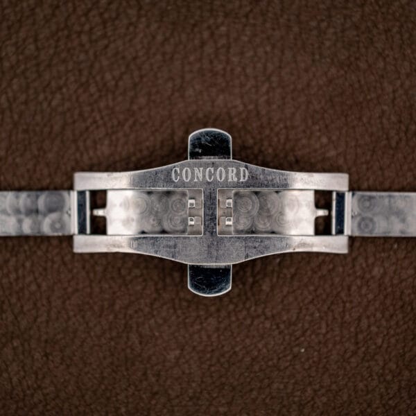 Folding clasp opened to show the Concord signature engraved across its steel cover