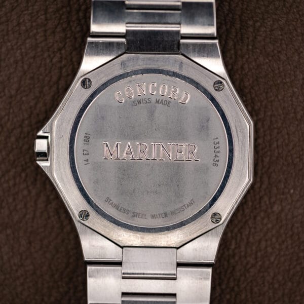 Screwed caseback stamped Concord, Mariner, reference 14 E7 1881 and the serial number, photographed straight on