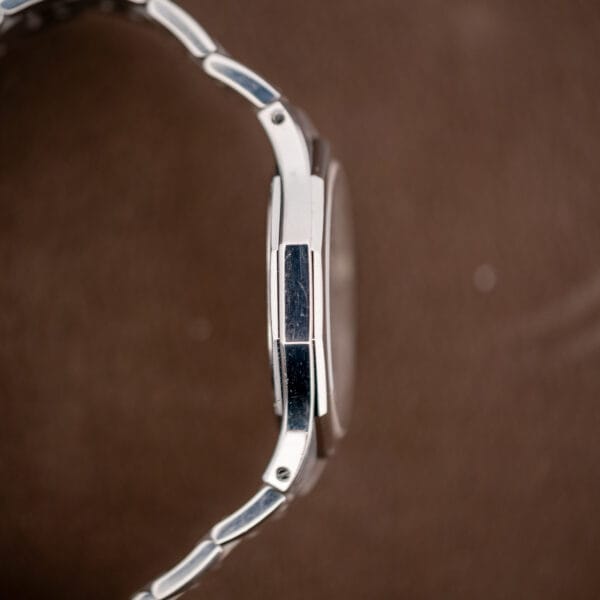 Profile from the nine o'clock side showing honest wear along the case flank and bracelet
