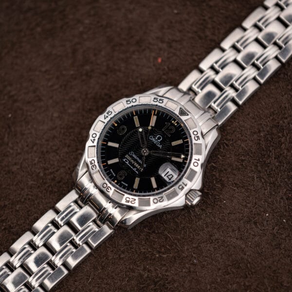 Three quarter view of the Omega Seamaster 200M with its steel bracelet curving away from the case.