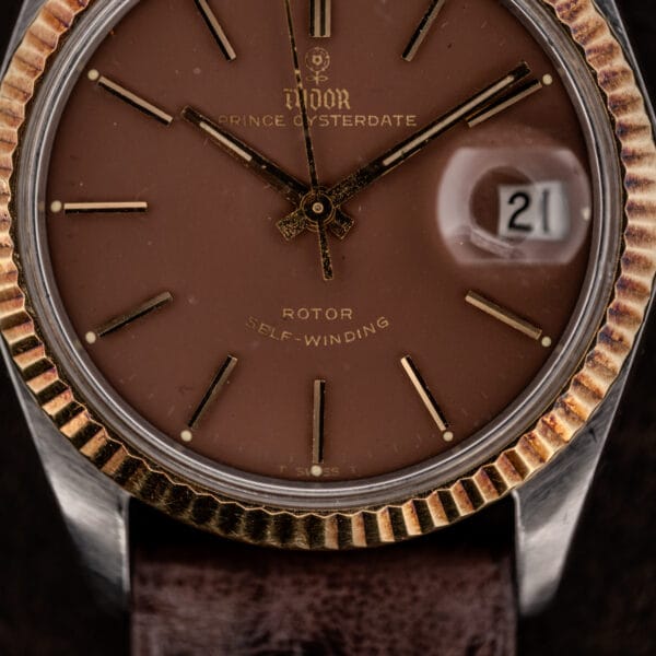 Tudor Prince Oysterdate rose dial macro with gilt markers, cyclops date window, and T SWISS T printing