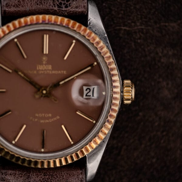 Tudor Prince Oysterdate crown-side view with fluted gold bezel and magnified date window