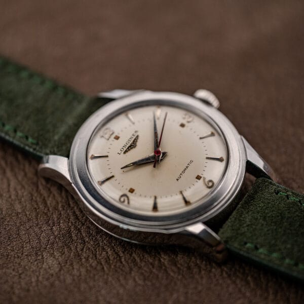 Three-quarter hero of the vintage Longines Sei Tacche with stepped polished bezel and faceted lug tops