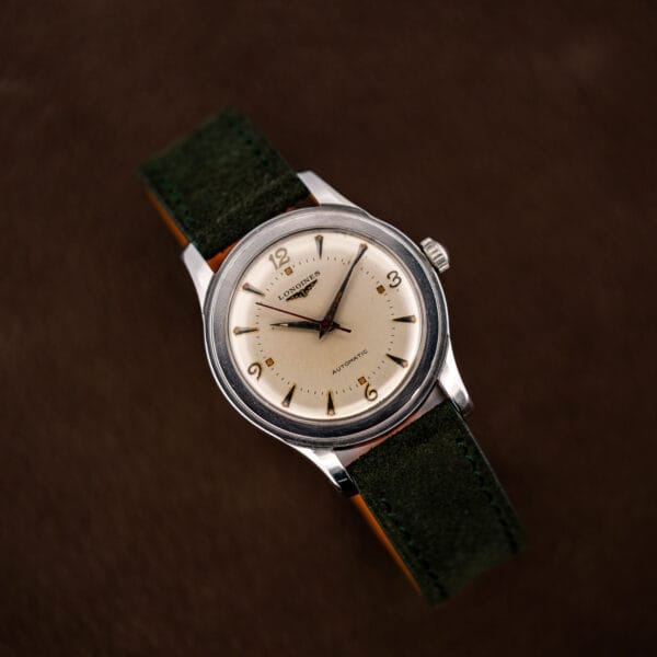 Vintage Longines Sei Tacche 6280-5 angled hero showing cream dial, aged amber lume and polished steel case