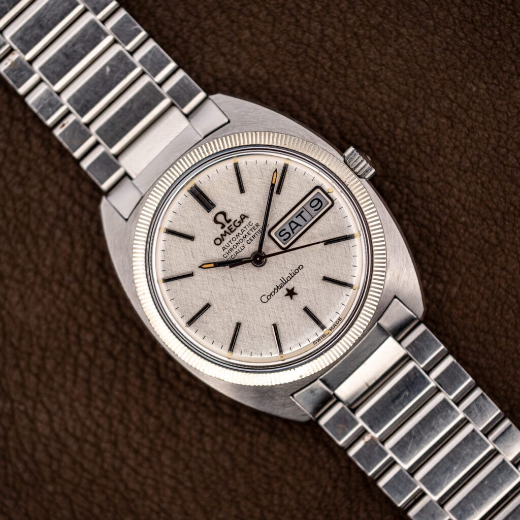 Omega Constellation 168.029 linen dial with fluted bezel and steel bracelet, day date reading SAT 9