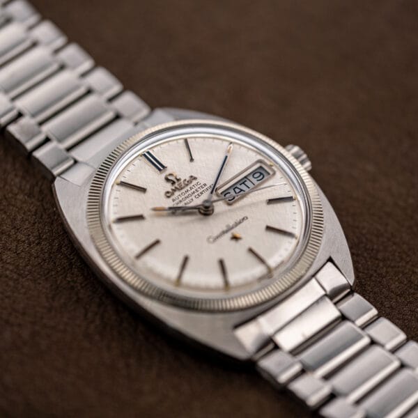 Angled Omega Constellation 168.029 catching raking light across the linen weave, fluted bezel and domed case top