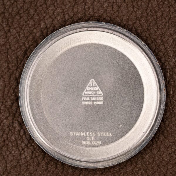 Inner caseback stamped OMEGA WATCH Co triangle, FAB. SUISSE, SWISS MADE, STAINLESS STEEL and reference 168.029