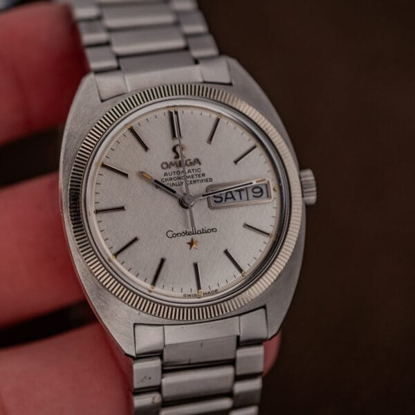 Omega Constellation linen dial in raking light with applied baton markers and the gilt Constellation star