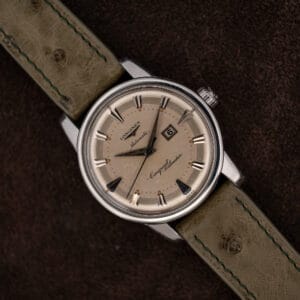 Longines Conquest Calendar 9004-3 front view, cream dial, applied arrow markers, date at three, olive strap