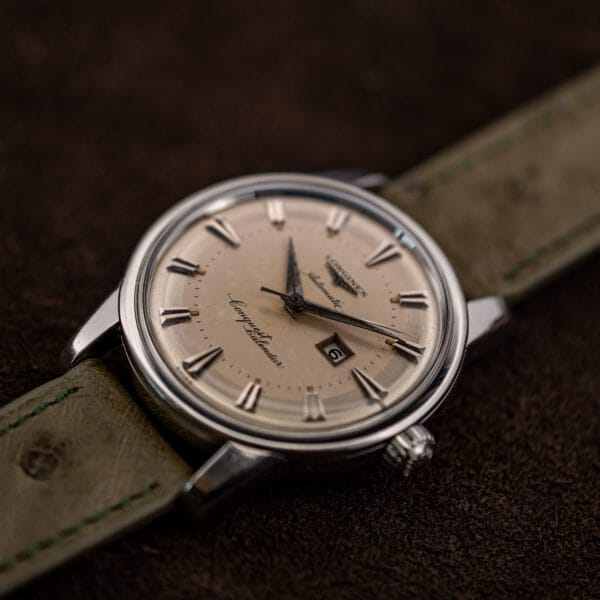 Three-quarter glamour shot of the Conquest Calendar showing its tall domed crystal and polished steel case