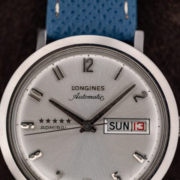 Sunburst dial detail on the Longines Admiral with applied Arabic numerals, doubled baton at eleven and blue strap