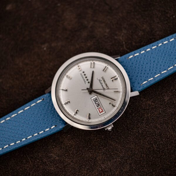 Angled view of the Longines Admiral slim polished steel case, domed acrylic crystal and small fluted crown at three
