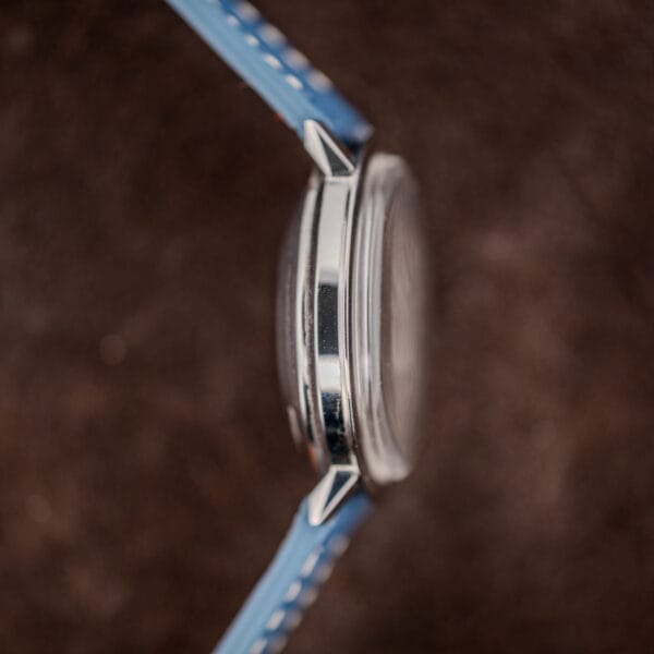 Nine o'clock profile of the Longines Admiral showing the separate bezel ring seam above the polished stainless steel mid case