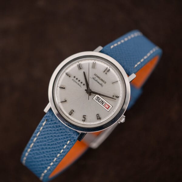 Hero angle of the Longines Admiral automatic on our blue leather strap with contrasting orange lining and cream stitching