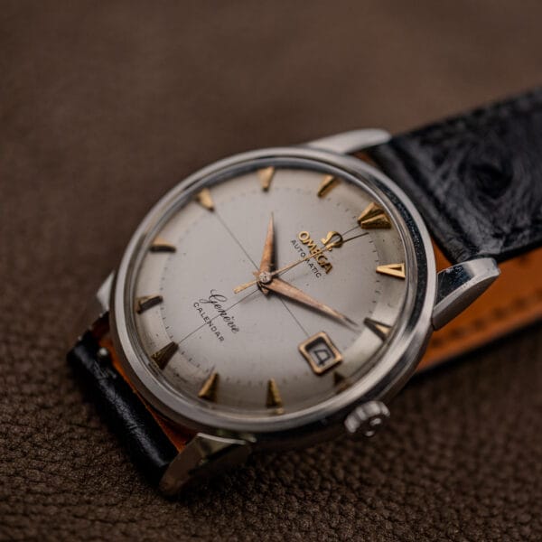 Omega 2982-3 SC at a raking angle revealing dial speckling, aged markers and the tan-lined ostrich strap