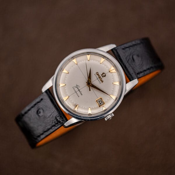 Reassembled Omega Geneve Calendar 2982-3 SC on its black ostrich strap, cream crosshair dial facing up