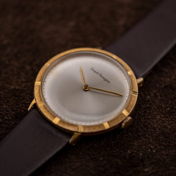Angled view of the Girard-Perregaux sunburst dial catching light across its stepped chapter ring and polished bezel notches