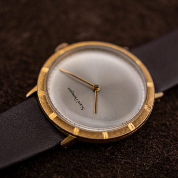 Girard-Perregaux seen from the twelve o'clock side, showing the blank lower dial and twelve notches cut through the bezel