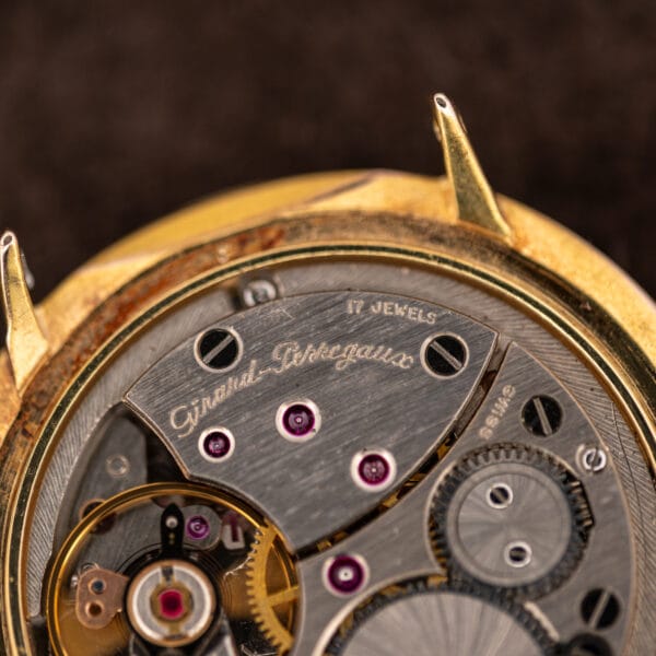 Girard-Perregaux movement bridge engraved with the brand script, seventeen jewel count and Swiss marking, five ruby jewels visible
