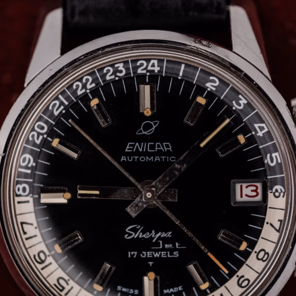 Printed 24-hour ring numerals and aged cream tritium plots on a vintage Enicar Sherpa Jet dial