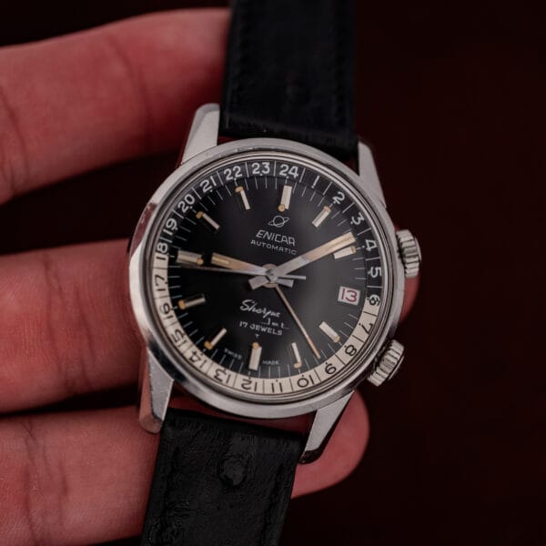 In-hand angle showing the Enicar Sherpa Jet case band height and both knurled compressor crowns