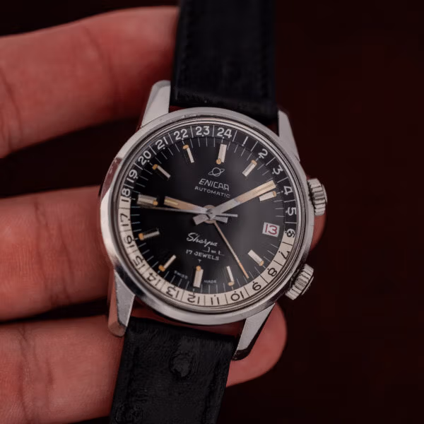 In-hand angle showing the Enicar Sherpa Jet case band height and both knurled compressor crowns