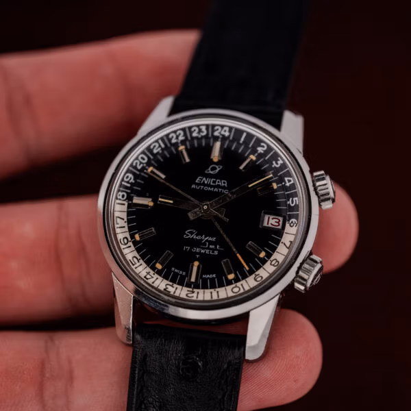 Open hand holding the Enicar Sherpa Jet, showing the mid-size steel case in real-world scale