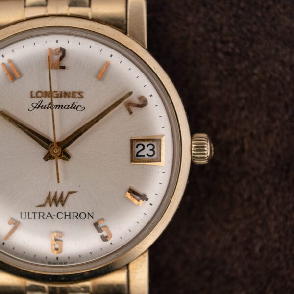 Longines Ultra-Chron Ref. 69-556 seen from the three o'clock side, fluted gold-tone crown and domed crystal in view