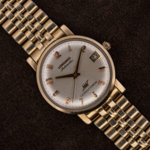 Longines Ultra-Chron automatic, silver sunburst dial with applied rose gold numerals and date at three, on gold-tone bracelet