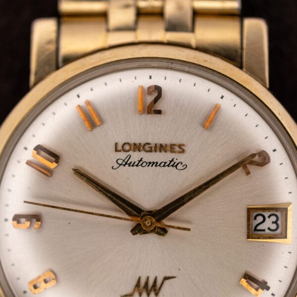 Macro of the Longines Ultra-Chron dial showing applied LONGINES lettering, printed Automatic script and worn gold dauphine hands