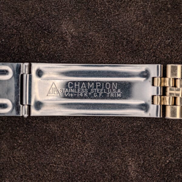 Bracelet clasp interior stamped CHAMPION, STAINLESS STEEL U.S.A. and 1/10-14KT G.F. TRIM with a triangular JB mark