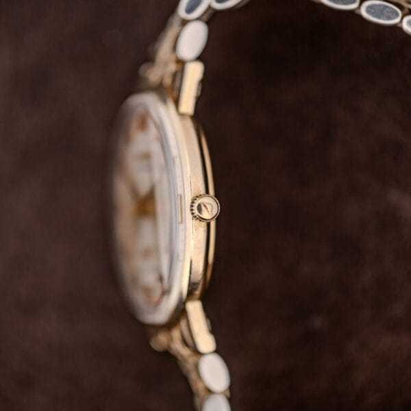 Side profile of the Longines Ultra-Chron focused on the fluted crown, slim case band and low domed crystal