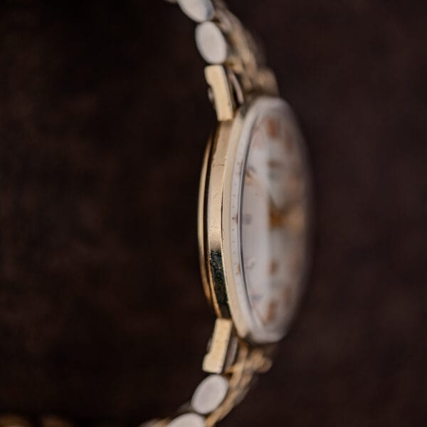 Nine o'clock profile of the Longines Ultra-Chron Ref. 69-556 gold filled case showing honest wear along the band