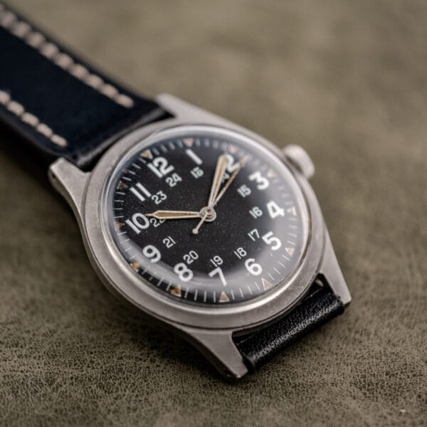 Matte black GG-W-113 dial on the Benrus pilot spec, uneven lume plots and bead-blasted steel case with drilled lugs