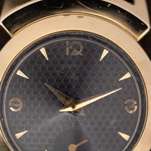 Lord Elgin Black Knight dial macro showing applied gold 12, 3 and 9 numerals and faded printing