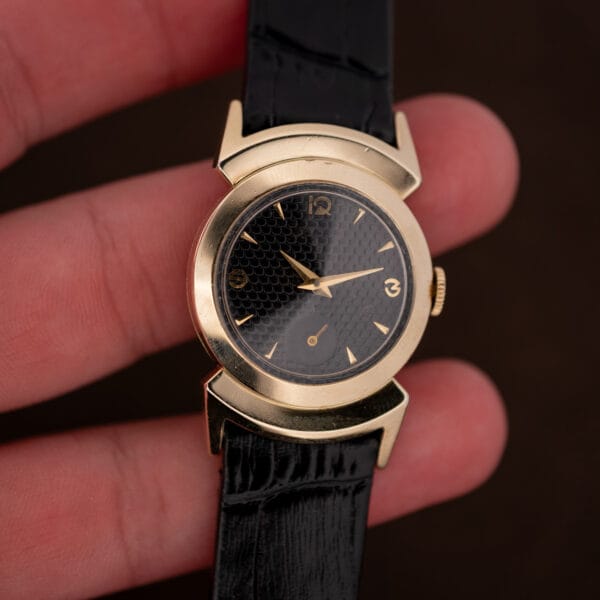 Lord Elgin Black Knight held in hand for scale, black honeycomb dial and gold filled case