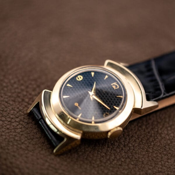 Low-angle view of the Lord Elgin Black Knight showing raised crystal, wide bezel and sculpted lug shrouds