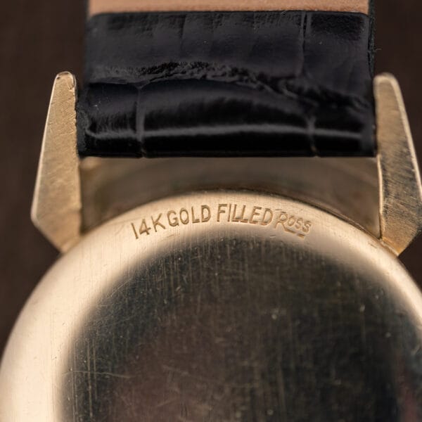 Macro of the Lord Elgin caseback stamp reading 14K GOLD FILLED ROSS above the lug shroud