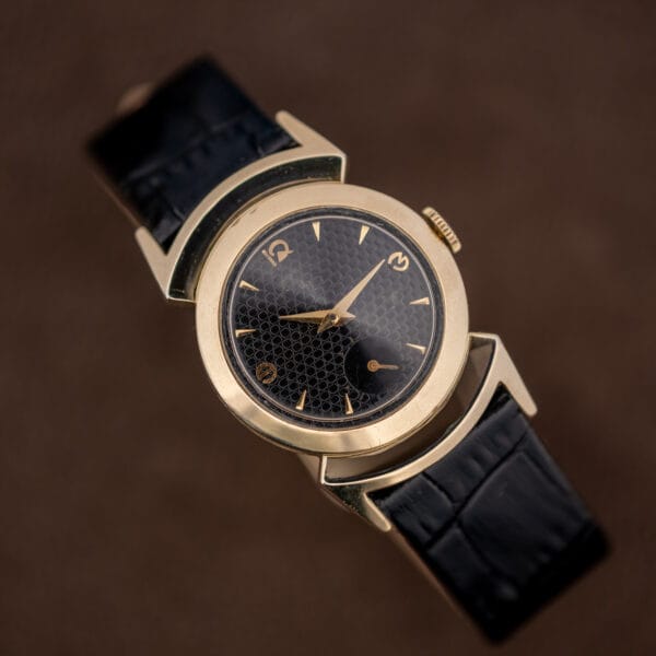 Top-down Lord Elgin Black Knight dial, gold dauphine hands, dagger markers and sub-seconds at six
