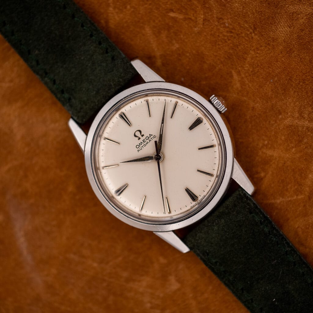Vintage Omega 14773-1 automatic with white dial and dauphine hands on forest green Italian suede strap