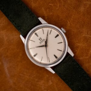 Vintage Omega 14773-1 automatic with white dial and dauphine hands on forest green Italian suede strap