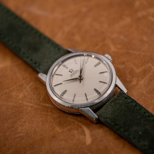 Omega 14773-1 stainless steel dress watch showing dial aging, tarnished dauphine hands and lightly scratched acrylic crystal