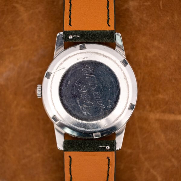 Omega 14773-1 caseback exterior with hand engraved Christmas 1961 inscription in the scratched recessed center medallion