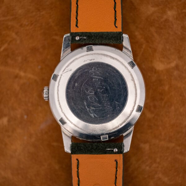 Rear of Omega 14773-1 showing Christmas 1961 engraving and six tool notches worn into the caseback rim