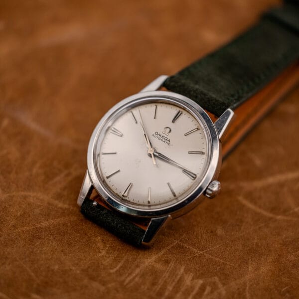 Vintage Omega automatic 14773-1 with Swiss Made dial printing, steel case hairlines and dark suede strap