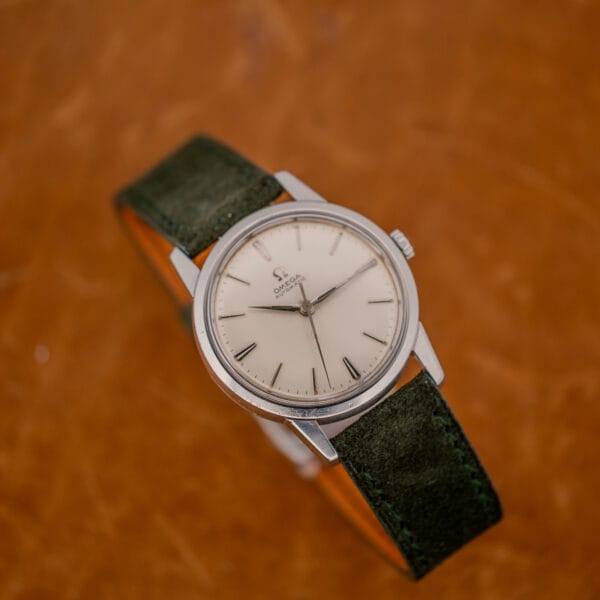 Omega 14773-1 dress watch with white dial, smooth steel bezel and forest green Italian suede strap