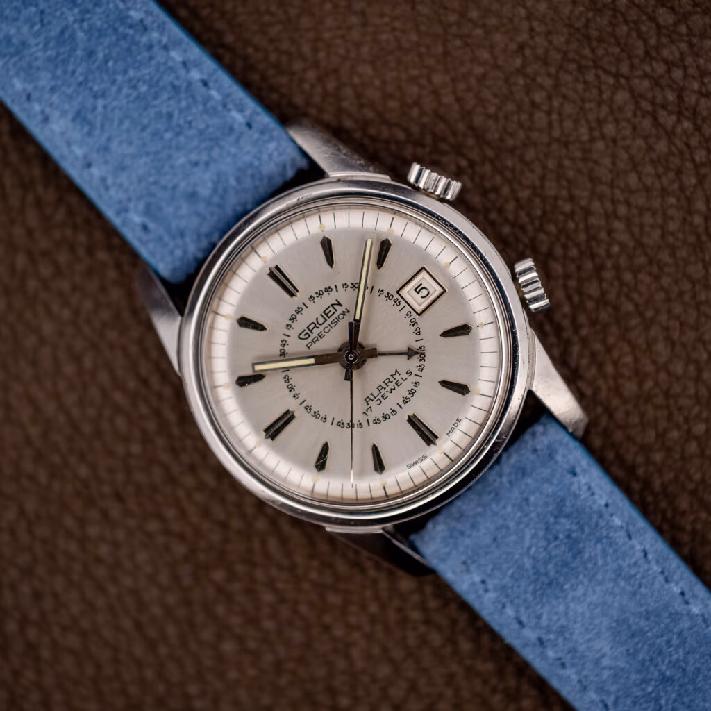 Vintage Gruen Precision Alarm on powder blue suede strap, silver sunburst dial with twin crowns at right