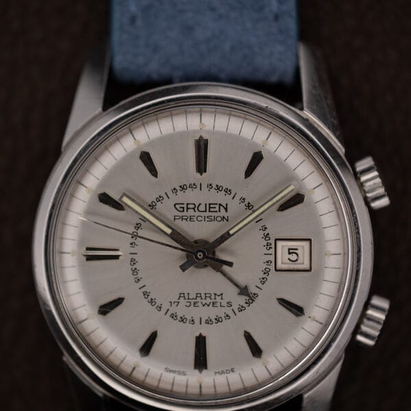 Gruen Precision Alarm dial close-up showing the inner alarm scale, date window and both case crowns